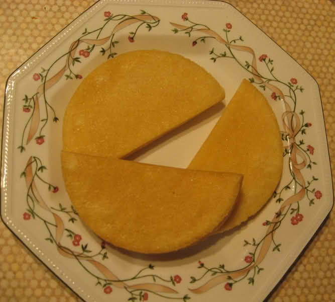 A plate displaying three pieces of Bammies, cut in half-circle shapes