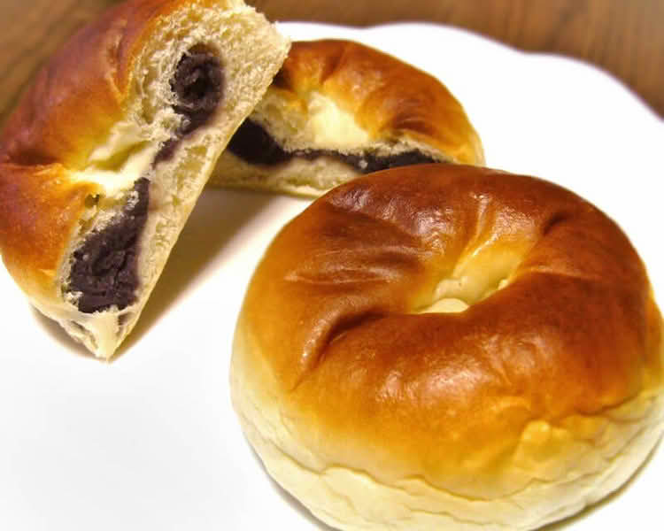 A plate of two Anpan, a traditional Japanese sweet bread filled with red bean paste